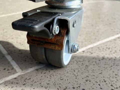 Rust visible around the brake spring on outdoor furniture castors