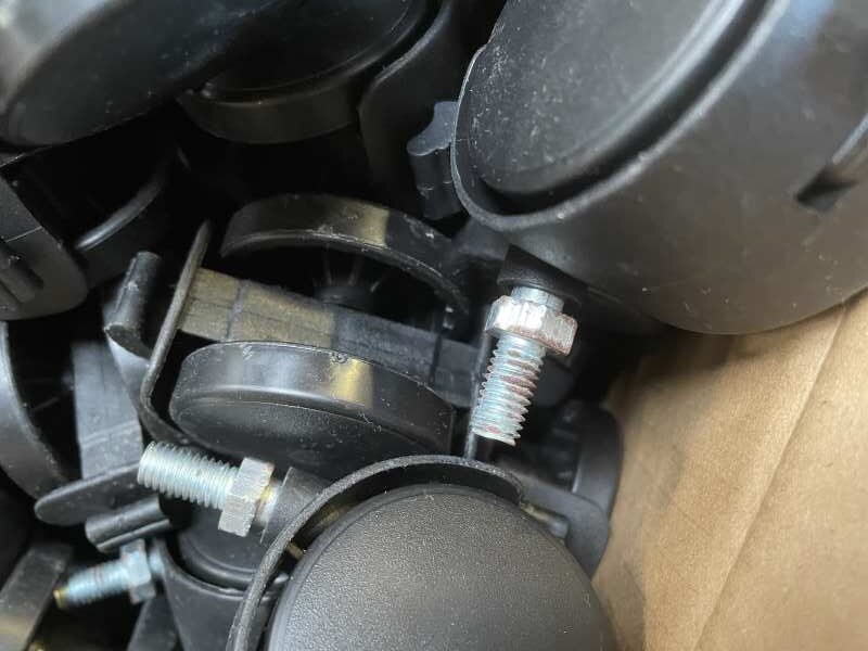Small black nylon castor with visible threaded-stem corrosion