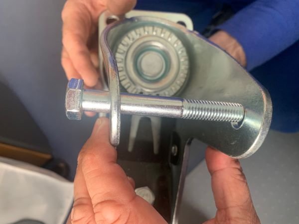 Close view of a heavy duty swivel castor housing and axle hardware